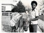Young Paper Boy with A Donkey Outside of the Tyler State College Campus on Berta Street by University of Texas at Tyler